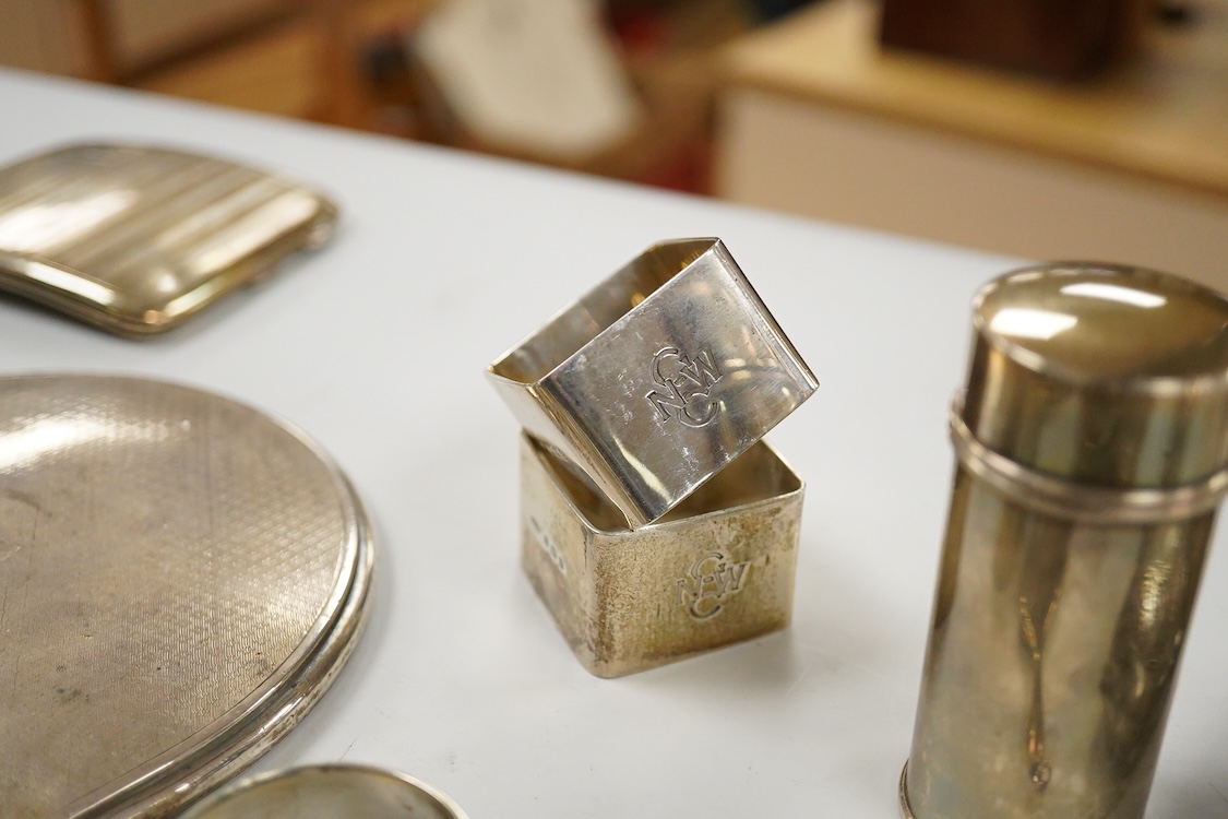 Sundry small silver, including two cigarette cases, a match sleeve holder, three napkin rings, two condiments, matchbox sleeve, shaving brush canister, commemorative small dish, a mounted hand mirror and mounted handbag